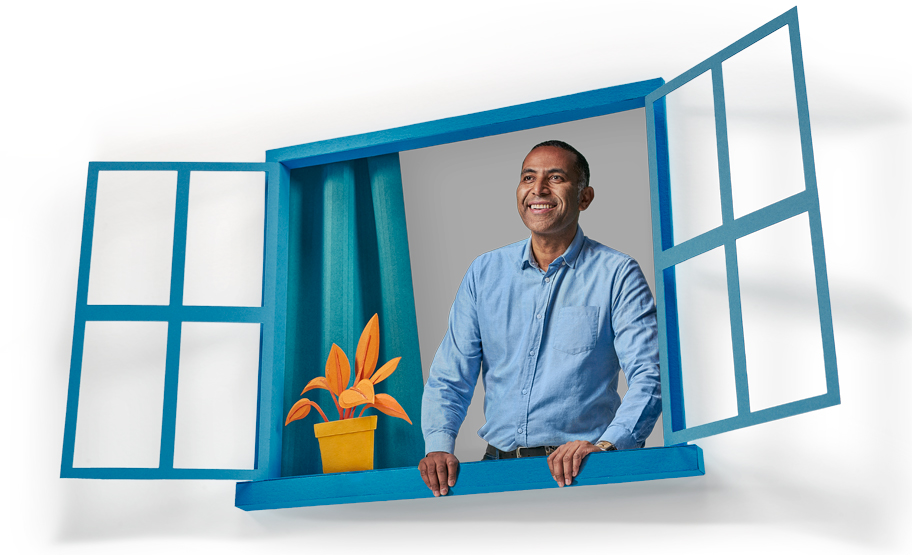 Image of a man smiling looking out an open window 