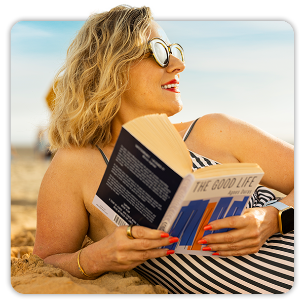 close up image of a woman reading on the beach